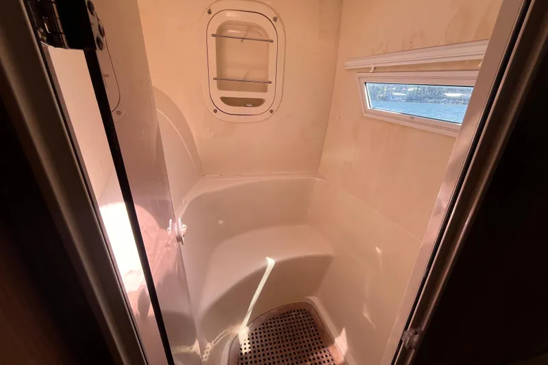 Slide: The Image of Compact bathroom interior of 2008 Broadblue 415 catamaran with window and shelving. - 48