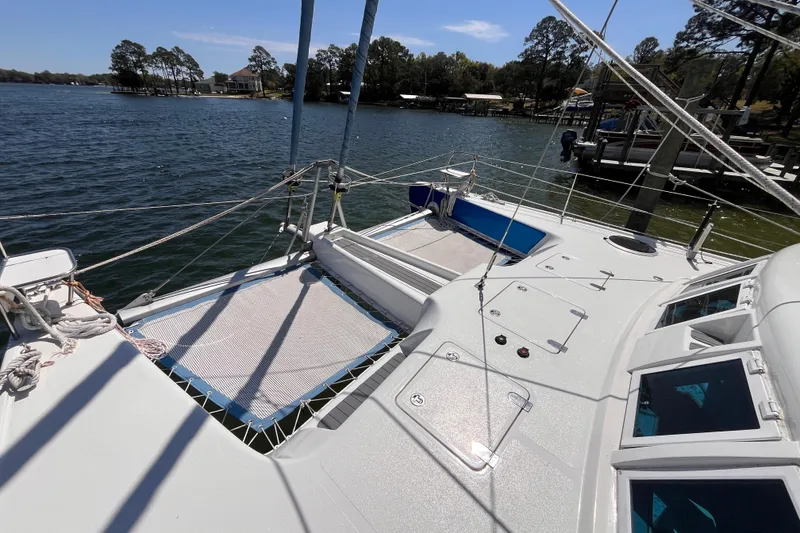 Slide: The Image of Sailing catamaran Broadblue 415, 2008 model, docked on a serene lake. - 5