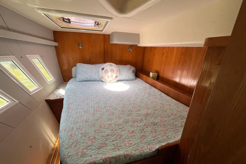 Slide: The Image of Cozy cabin interior of 2008 Broadblue 415 catamaran with quilted bedspread and porthole windows. - 53