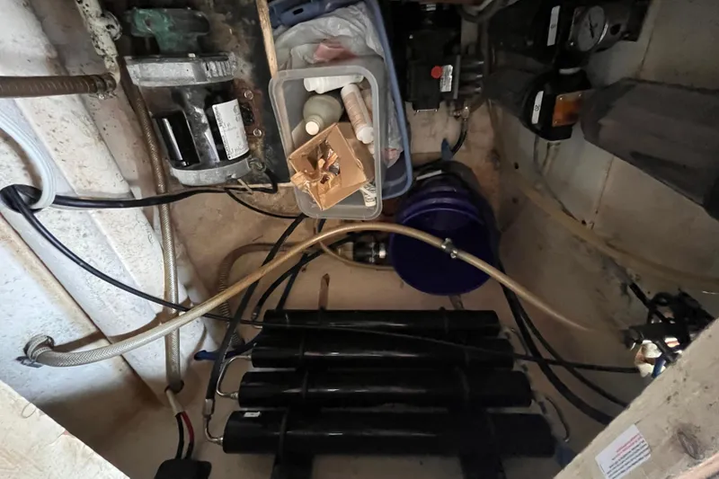 Slide: The Image of Engine compartment of a 2008 Broadblue 415 catamaran, showing mechanical components and storage. - 54