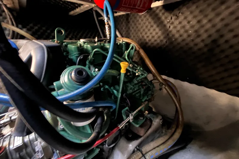 Slide: The Image of Engine compartment of a 2008 Broadblue 415 catamaran, featuring hoses and mechanical components. - 64