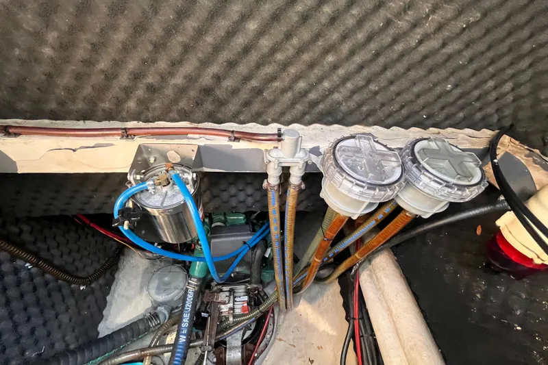 Slide: The Image of Engine compartment of a 2008 Broadblue 415 catamaran, featuring fuel filters and hoses. - 73
