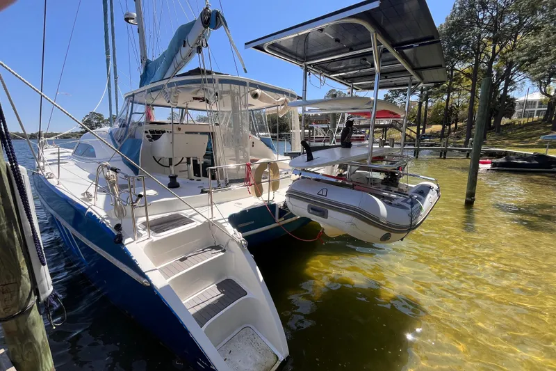 Slide: The Image of 2008 Broadblue 415 catamaran docked with inflatable dinghy, under clear blue sky. - 78