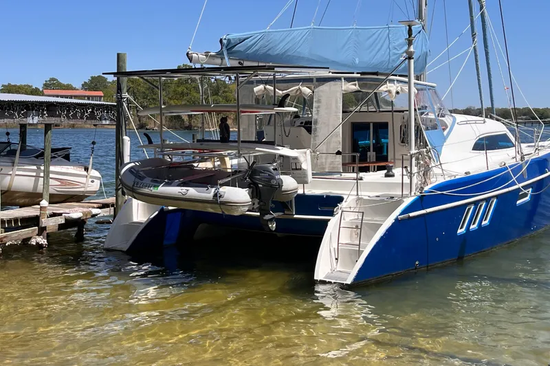 Slide: The Image of 2008 Broadblue 415 catamaran docked with inflatable boat, clear water, and blue sky. - 79