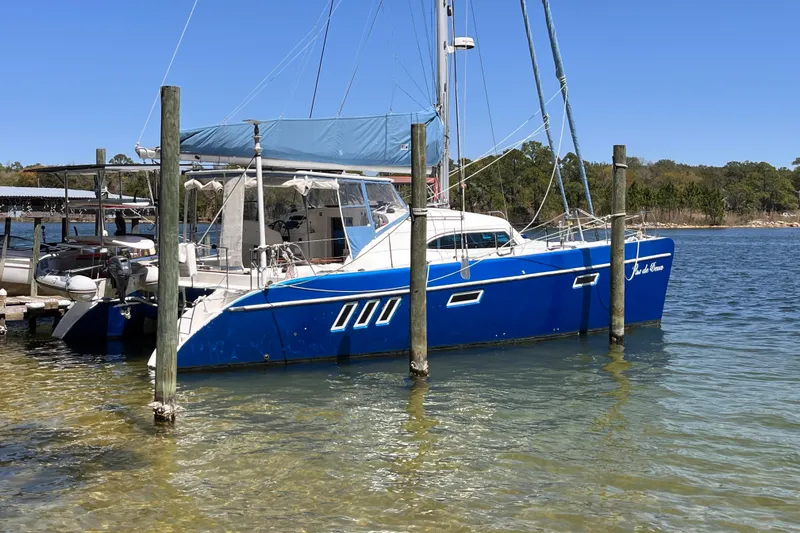 Slide: The Image of Blue 2008 Broadblue 415 catamaran docked in a serene marina setting. - 80