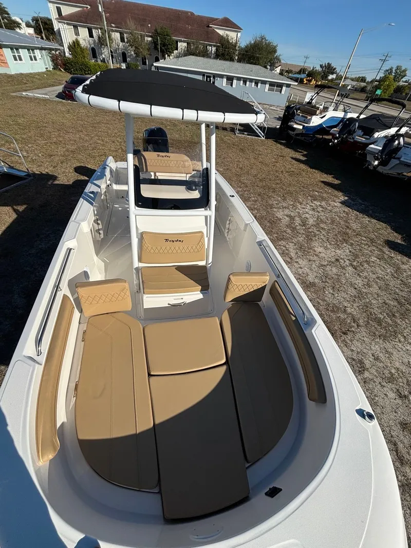 Slide: The Image of 2025 Trophy T24 CC boat with beige interior and black canopy. - 14