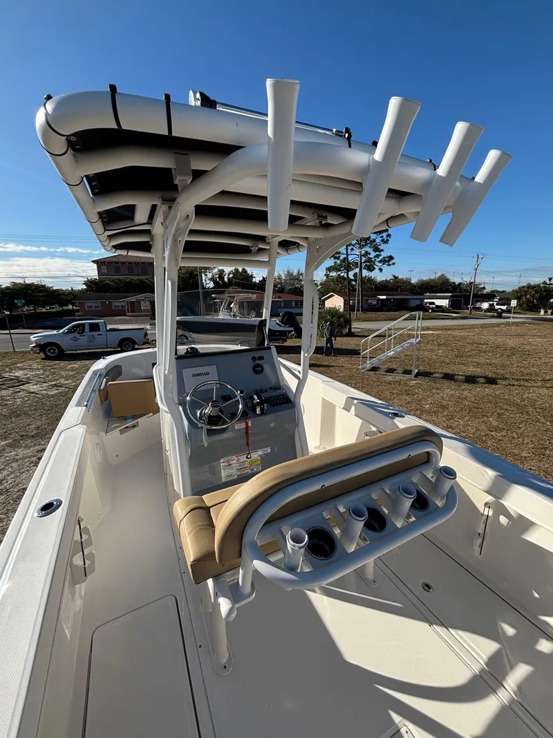 Slide: The Image of 2025 Trophy T24 CC boat with helm console and fishing rod holders. - 2