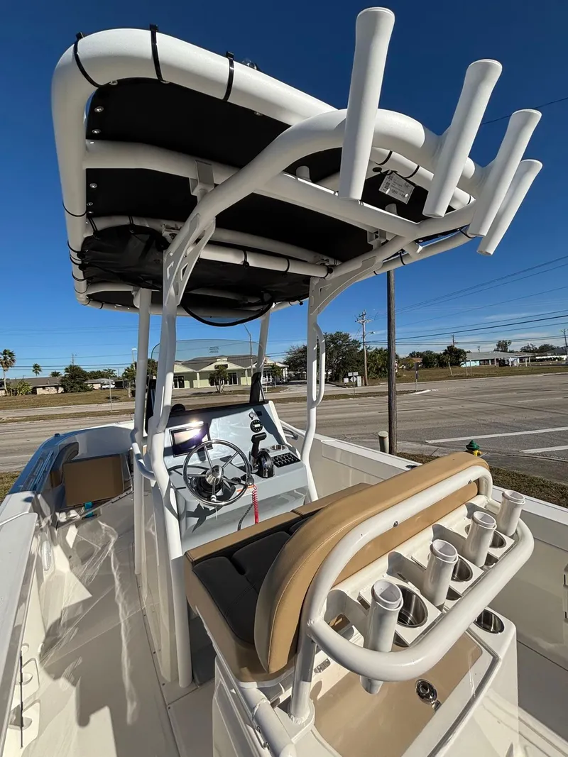 Slide: The Image of 2025 Trophy T24 CC boat with helm and fishing rod holders. - 2