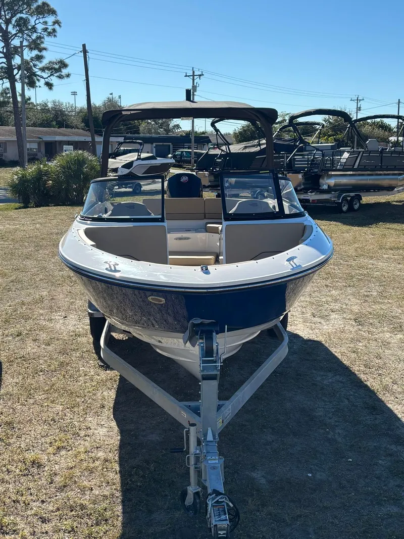 Slide: The Image of 2025 Bayliner V20 boat on trailer outdoors. - 11