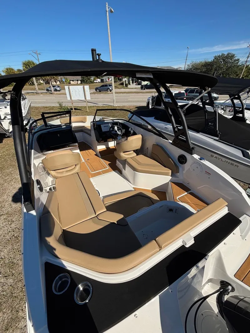 Slide: The Image of Interior view of Bayliner V20 boat, 2025 model, featuring beige seating. - 2
