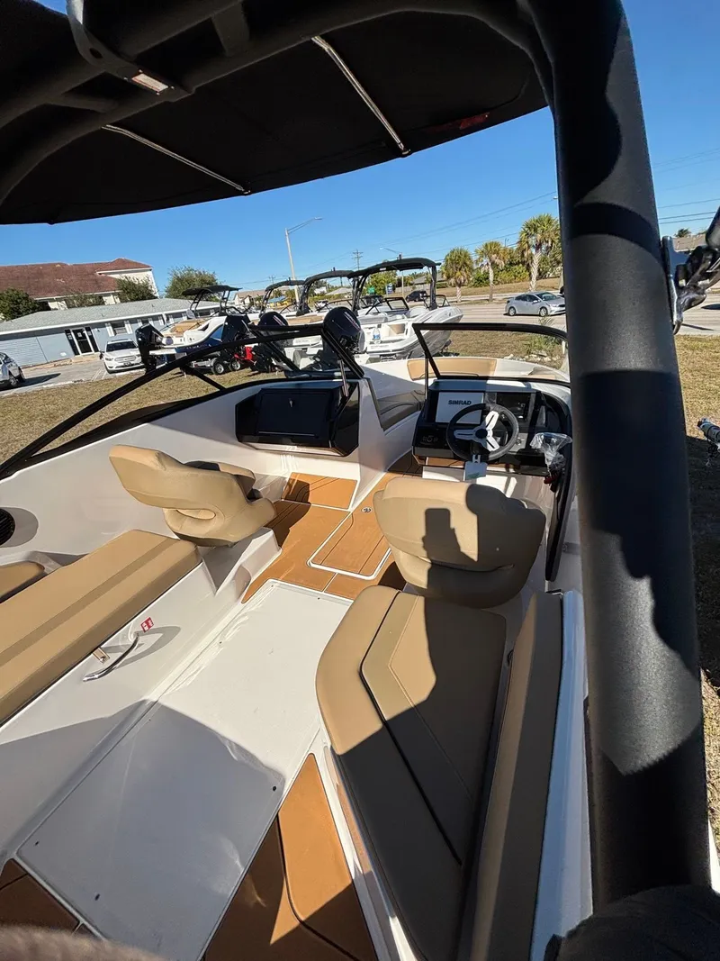 Slide: The Image of Interior of Bayliner V20 boat, 2025 model, featuring modern seating and helm console. - 6