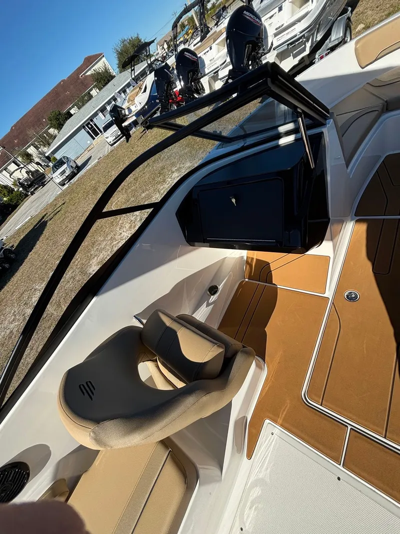 Slide: The Image of Interior of 2025 Bayliner V20 boat with beige seat and flooring. - 7