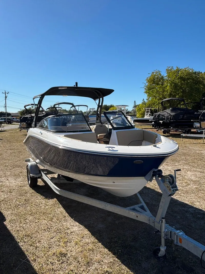 Slide: The Image of 2025 Bayliner V20 boat on trailer under sunny skies. - 8