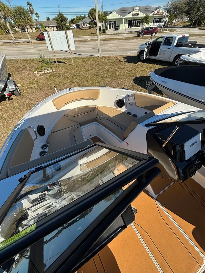 Slide: The Image of Interior of Bayliner V20 boat, 2025 model, featuring beige seating. - 9