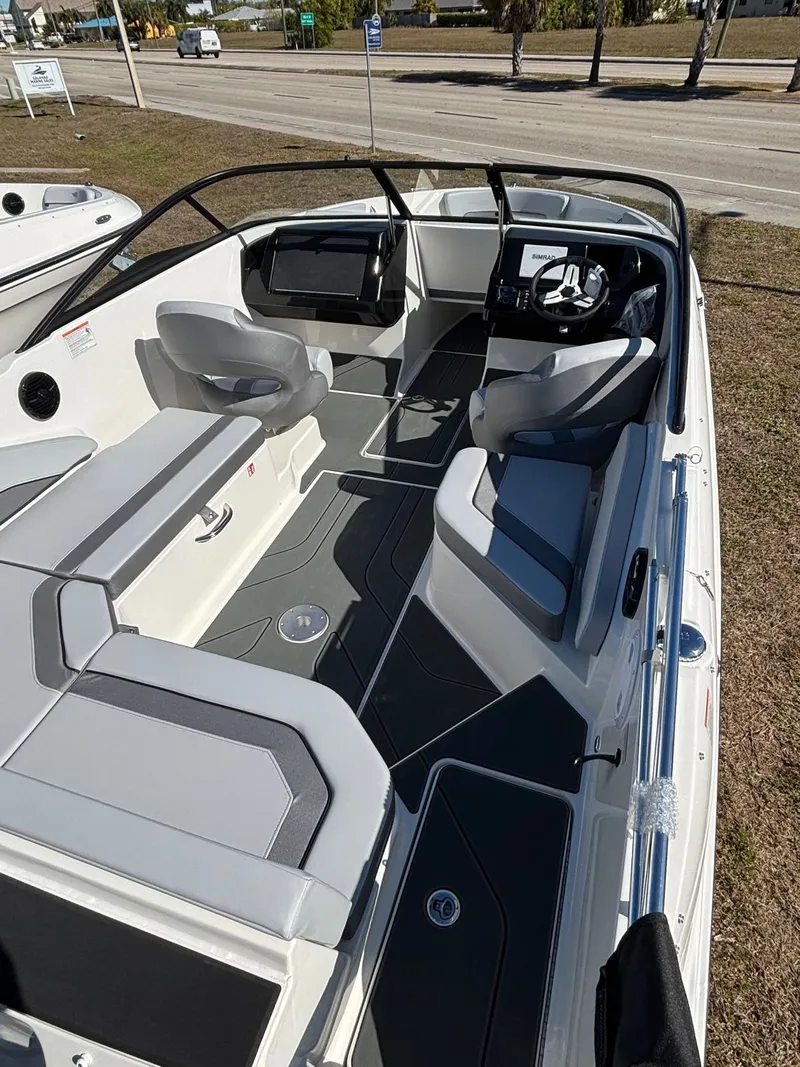 Slide: The Image of Interior of Bayliner V20 boat, 2026 model, featuring gray seating. - 12