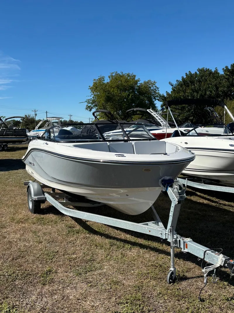 Slide: The Image of 2026 Bayliner V20 boat displayed outdoors on a trailer. - 6