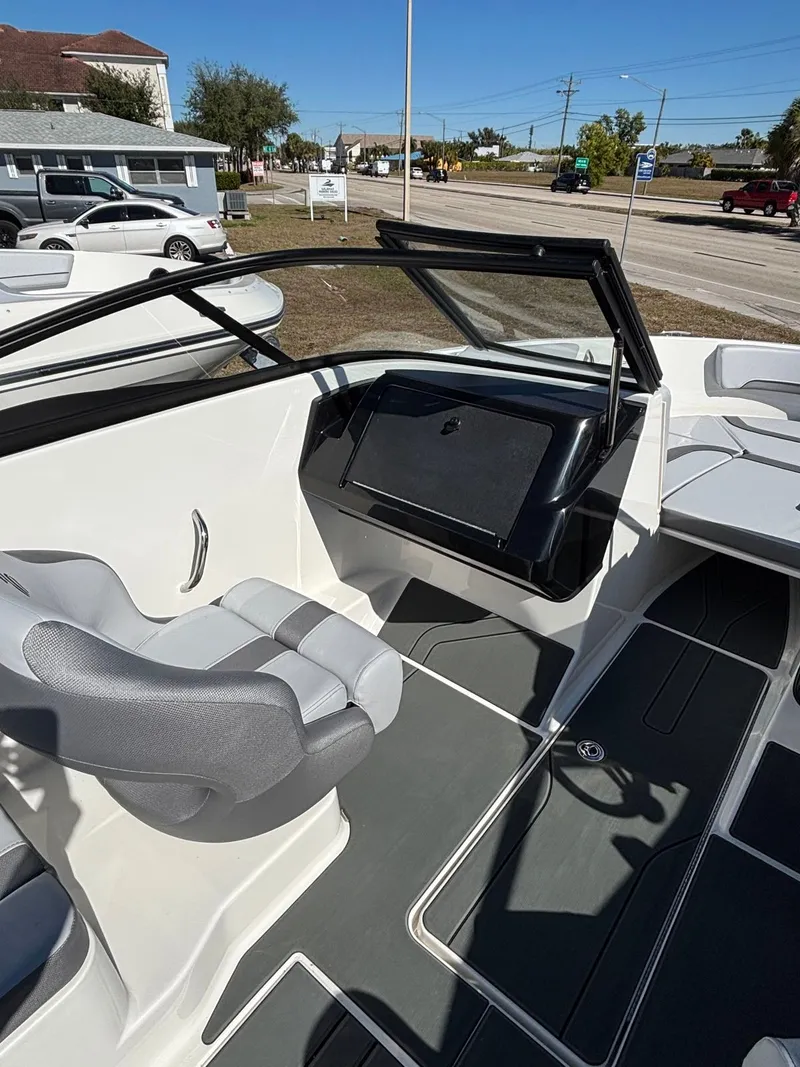 Slide: The Image of Interior of 2026 Bayliner V20 with gray seats and helm console. - 9