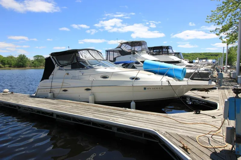 The Image of 2002 Regal Commodore 2860 boat docked at marina under clear blue sky. - 1