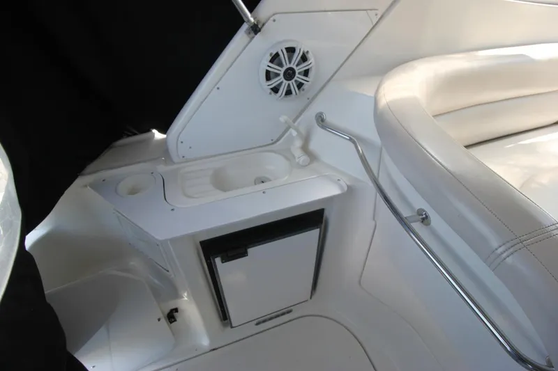 Slide: The Image of Interior of 2002 Regal Commodore 2860 boat with seating and mini fridge. - 11