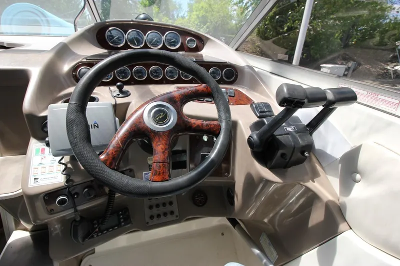 Slide: The Image of Helm of 2002 Regal Commodore 2860 boat with steering wheel and control panel. - 14