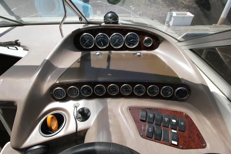 Slide: The Image of Control panel of a 2002 Regal Commodore 2860 boat with gauges and switches. - 15