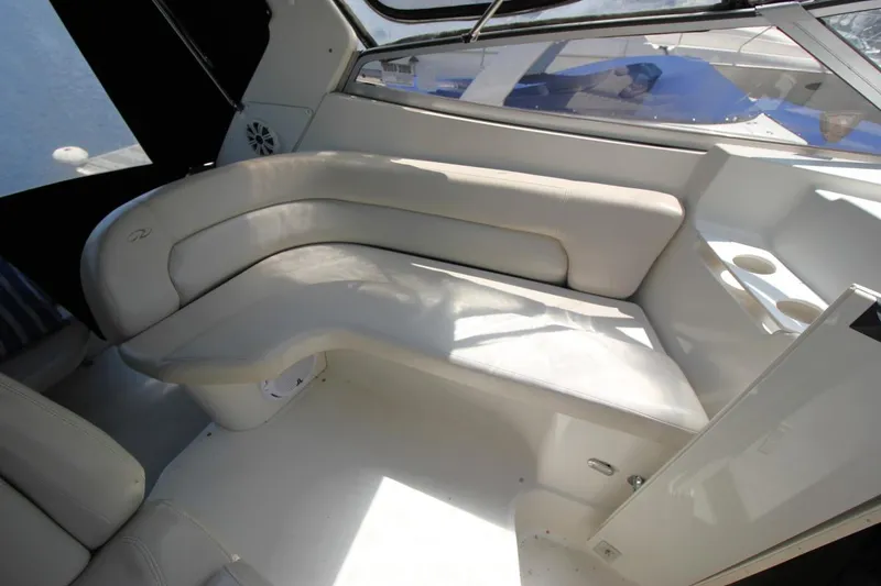 Slide: The Image of Interior of 2002 Regal Commodore 2860 boat with white seating and cup holders. - 17
