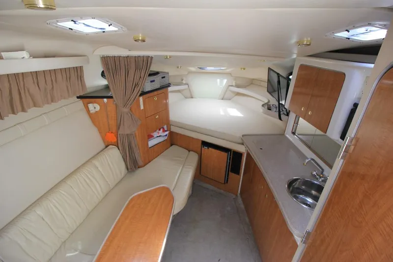 Slide: The Image of Interior of 2002 Regal Commodore 2860 boat with kitchenette and seating area. - 18