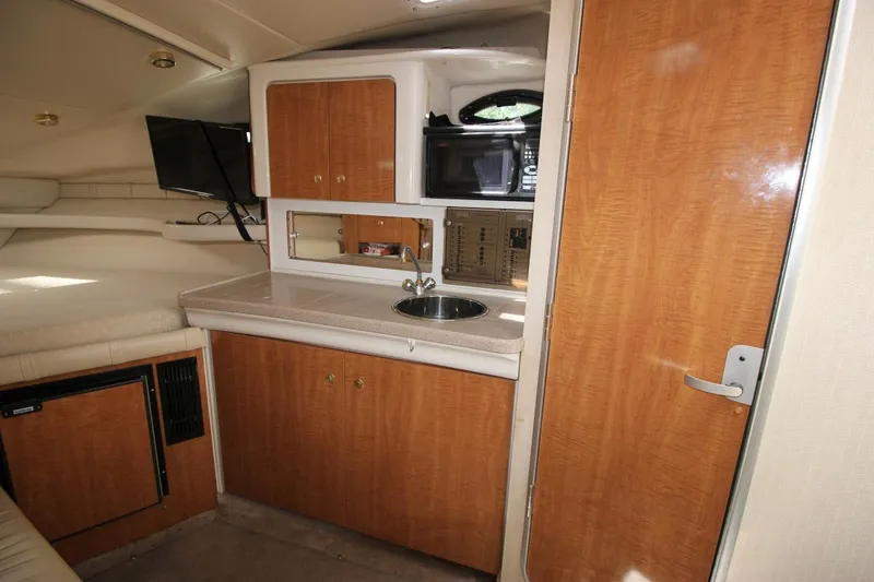 Slide: The Image of Interior of 2002 Regal Commodore 2860 boat with kitchenette and wood cabinetry. - 21