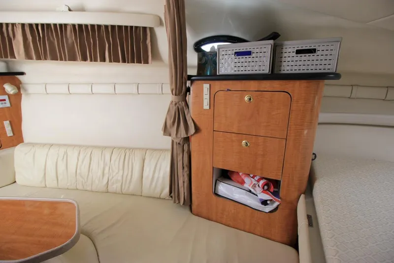 Slide: The Image of Interior of 2002 Regal Commodore 2860 boat with seating and storage cabinets. - 25