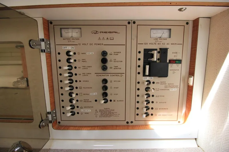 Slide: The Image of Control panel of a 2002 Regal Commodore 2860 boat, featuring switches and voltage meters. - 27