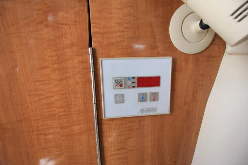 Slide: The Image of Control panel on 2002 Regal Commodore 2860 boat interior, featuring digital display and buttons. - 29