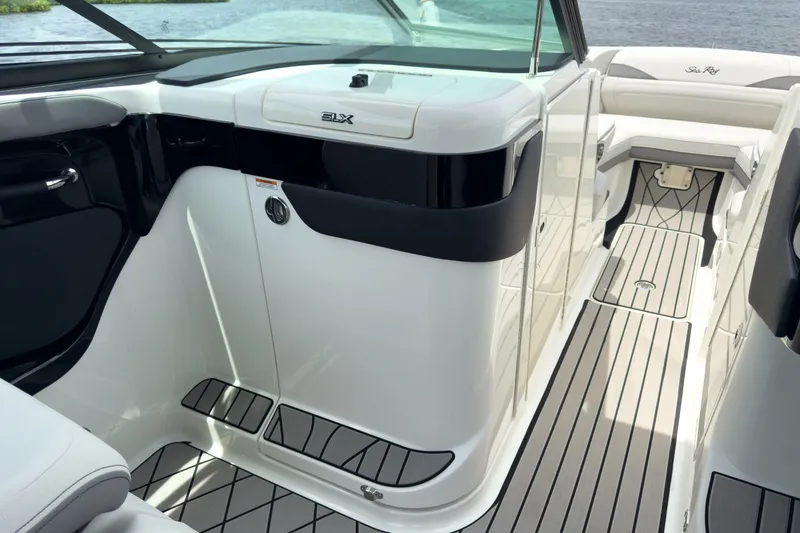 Slide: The Image of The image shows the cockpit of a 2027 Sea Ray SLX 280 Outboard with sleek white surfaces. - 16