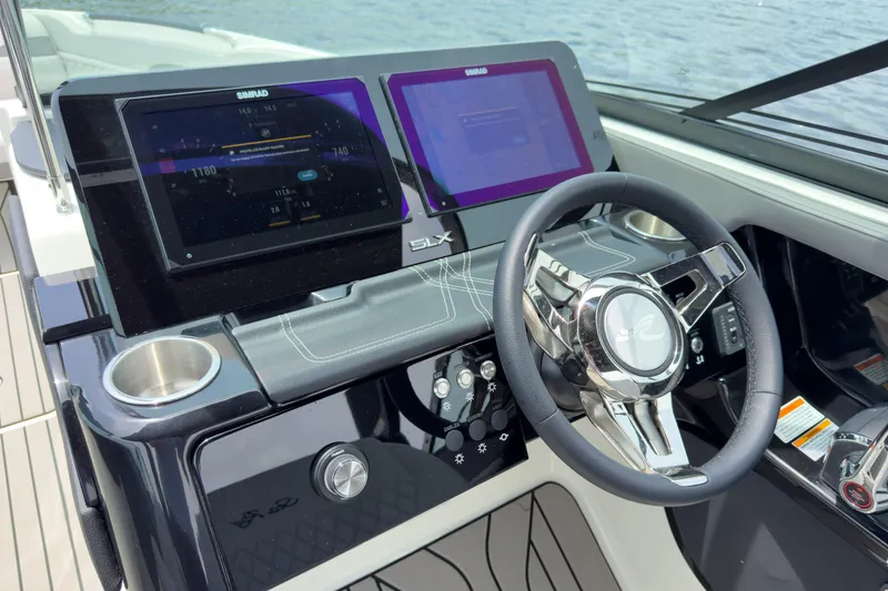 Slide: The Image of The image shows the helm of a Sea Ray SLX 280 Outboard with two digital displays and a sleek steering wheel. - 13