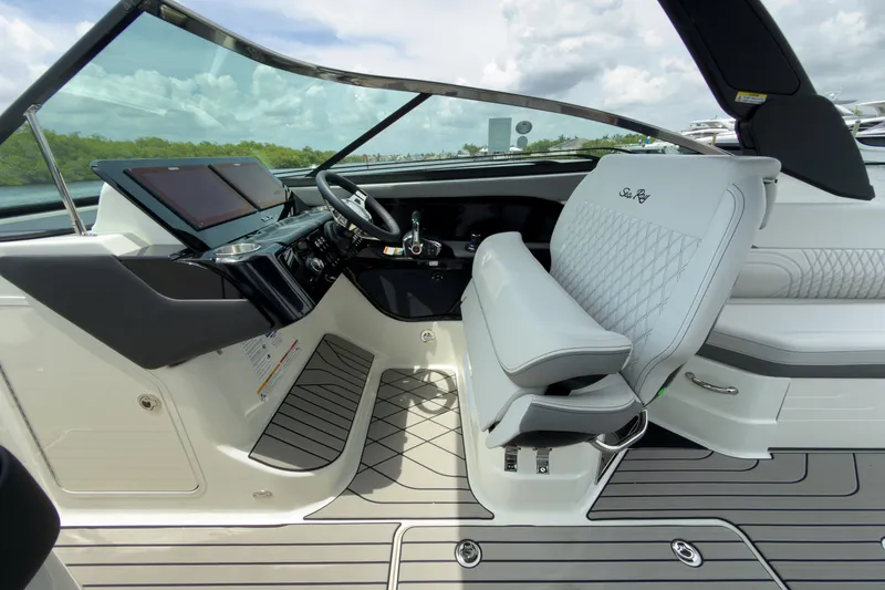 Slide: The Image of The image shows the cockpit of a 2027 Sea Ray SLX 280 Outboard with luxurious seating and modern controls. - 14