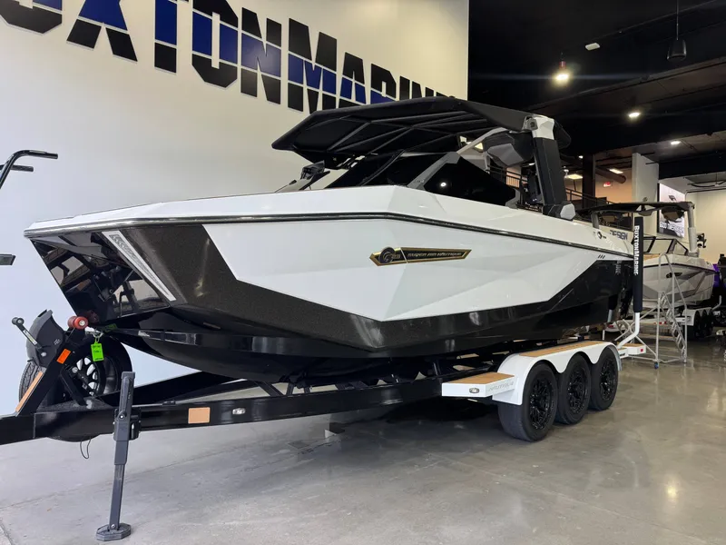 Slide: The Image of 2025 Nautique Super Air Nautique G23 boat in showroom. - 2