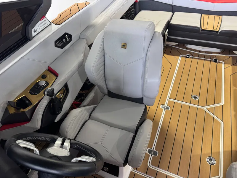 Slide: The Image of Interior of 2025 Nautique Super Air Nautique G23 with luxurious seating and controls. - 21
