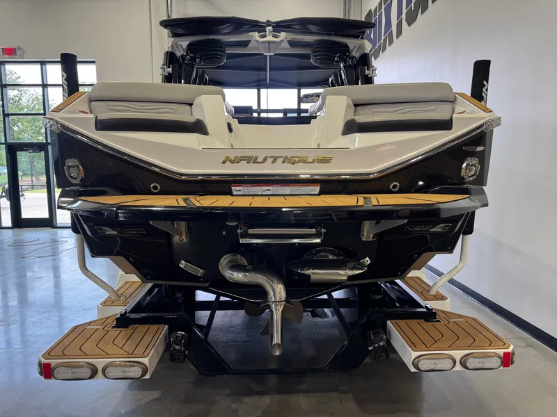 Slide: The Image of Rear view of 2025 Nautique Super Air Nautique G23 boat in showroom. - 6