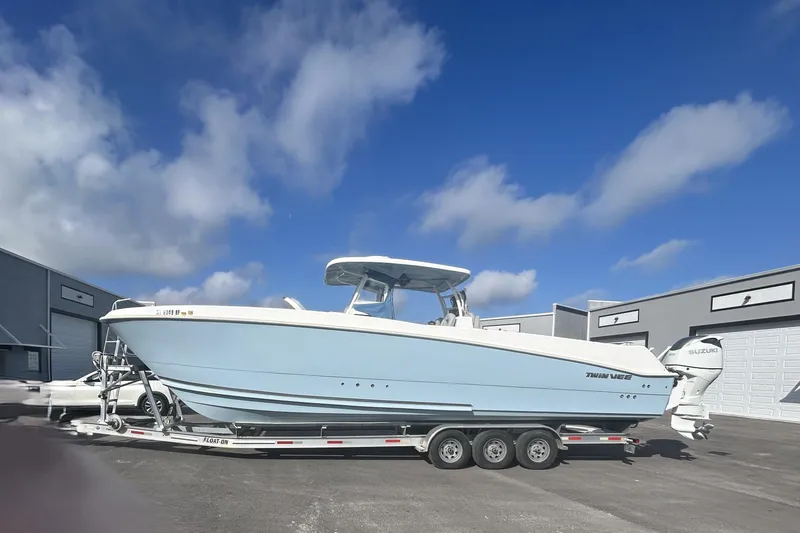 The Image of 2023 Twin Vee 340 GFX CC boat on trailer in front of storage buildings. - 0
