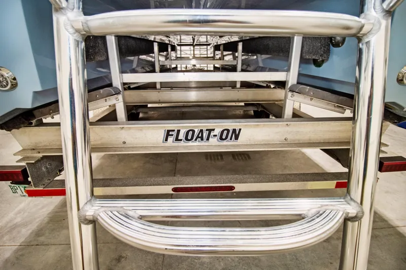 Slide: The Image of 2023 Twin Vee 340 GFX CC boat on a Float-On trailer, rear view. - 11