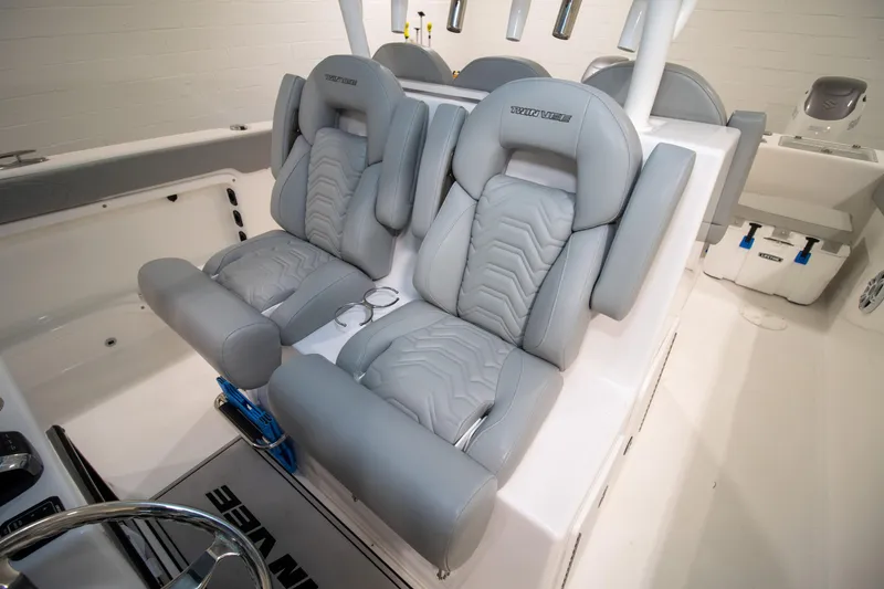 Slide: The Image of 2023 Twin Vee 340 GFX CC boat interior with luxurious gray seating and modern design. - 19