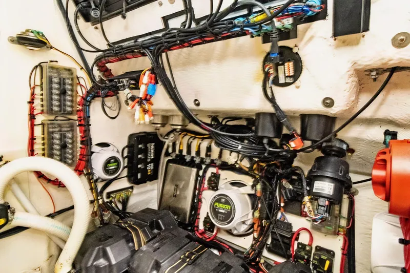 Slide: The Image of Engine compartment of 2023 Twin Vee 340 GFX CC, showcasing wiring and components. - 22