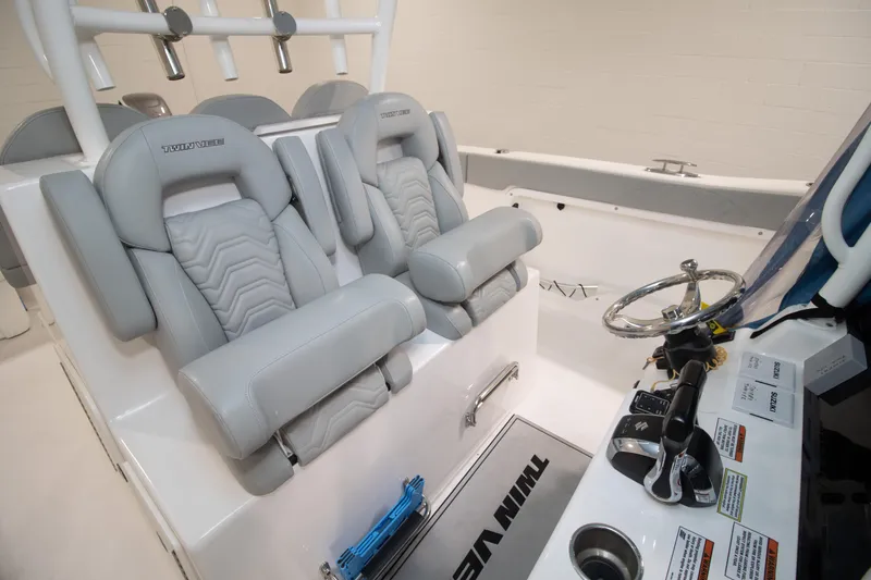 Slide: The Image of 2023 Twin Vee 340 GFX CC boat interior with plush seating and modern controls. - 24
