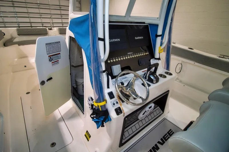 Slide: The Image of 2023 Twin Vee 340 GFX CC boat interior with steering console and Garmin displays. - 25