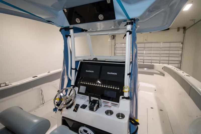 Slide: The Image of 2023 Twin Vee 340 GFX CC boat interior with Garmin navigation system and modern controls. - 26