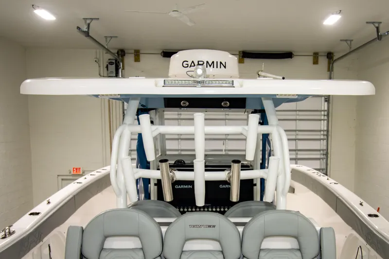 Slide: The Image of 2023 Twin Vee 340 GFX CC boat interior with Garmin equipment in a garage. - 27