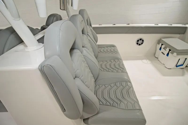 Slide: The Image of 2023 Twin Vee 340 GFX CC boat interior with gray cushioned seating and storage. - 28