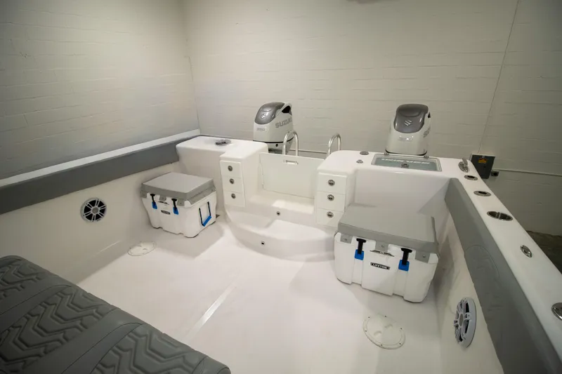 Slide: The Image of 2023 Twin Vee 340 GFX CC boat interior with Suzuki engines and storage coolers. - 29