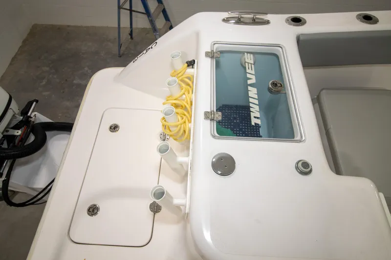 Slide: The Image of 2023 Twin Vee 340 GFX CC boat deck with storage compartments and hose holders. - 30