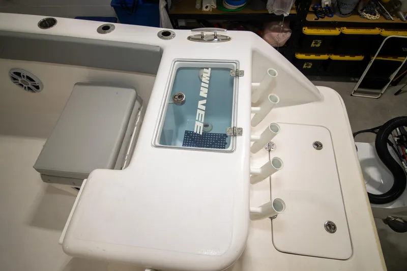 Slide: The Image of 2023 Twin Vee 340 GFX CC boat interior with rod holders and storage compartments. - 31