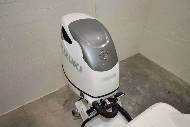 Slide: The Image of 2023 Twin Vee 340 GFX CC with Suzuki 350 outboard motor in a garage setting. - 33